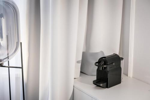 a black purse sitting on a white window sill at Pytloun Boutique Hotel Prague in Prague