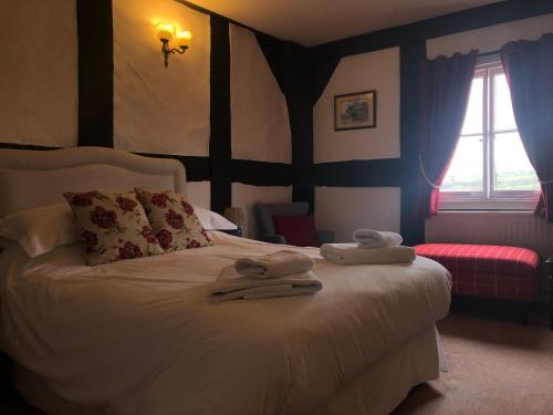 a bedroom with a bed with towels on it at Rhydspence in Hay-on-Wye