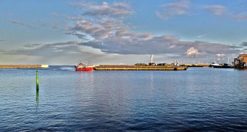 a large body of water with a boat in it at STF Baskemölla Hostel in Simrishamn