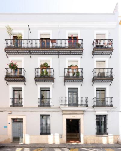 a white facade of a building with balconies at ELEVEN Apartments Real de la Carretería, by Homing U in Seville