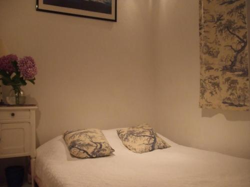a bedroom with a bed with two pillows on it at 7 MAISON DES SABLes in Grimaud
