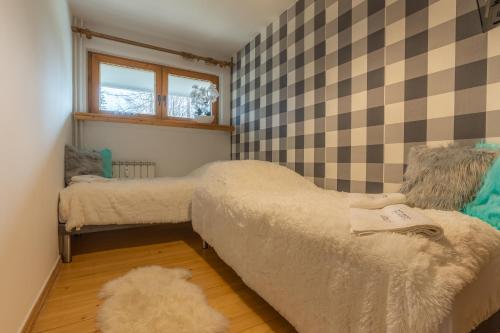 Posteľ alebo postele v izbe v ubytovaní Apartament Lisowski CENTRUM
