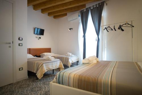 Postel nebo postele na pokoji v ubytování B&B Kolymbetra