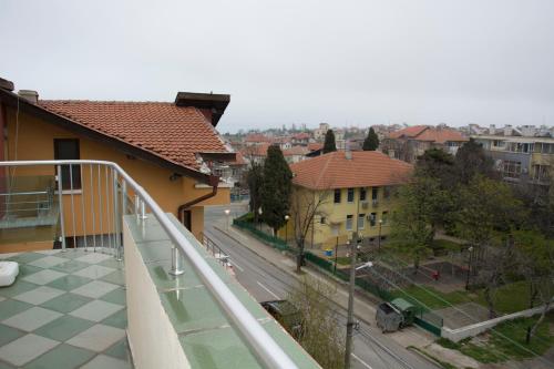 a balcony with a view of a street and buildings at Stedy Guest House in Chernomorets