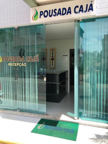 a glass entrance to a possada calaya building at POUSADA CAJÁ in Flores