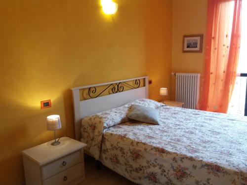 a bedroom with a bed with a white bedspread at I Boidi in Nizza Monferrato