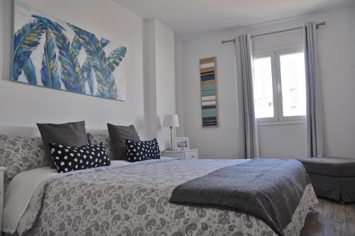 a bedroom with a large bed and a window at Casa Tere in Arrecife