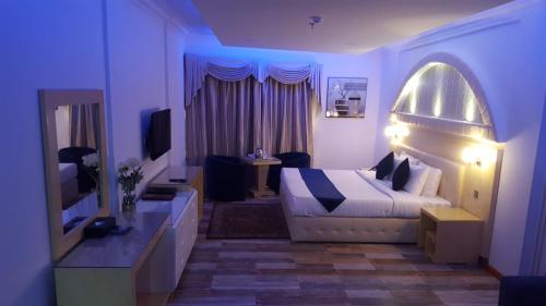 a hotel room with a bed and a television at Bahrain International Hotel in Manama