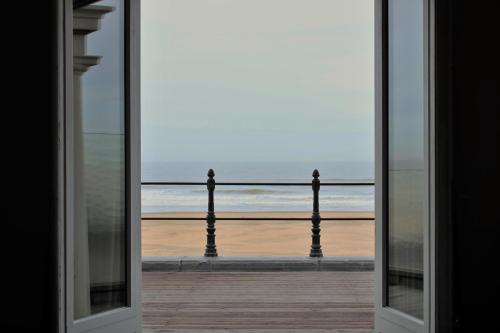 a view of the beach through a window at Thermae Palace in Ostend