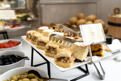 a display of different types of food on a table at Hotel Villa Baltica in Sopot