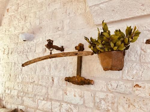 a basket filled with a bunch of leaves on top of a brick wall at Masseria Morrone in Ostuni