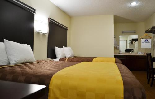 a hotel room with two beds and a kitchen at Americas Best Value Inn Calimesa in Calimesa