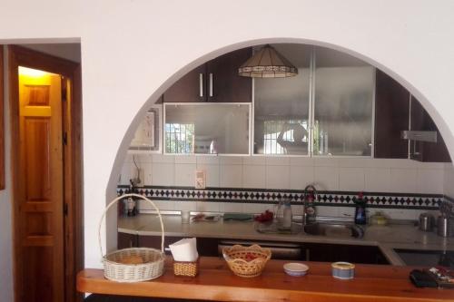 an archway in a kitchen with a sink and a counter at Una joya en la Alpujarra in Bubión