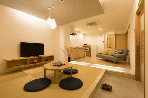 a living room with a couch and a table at Guesthouse Raku in Kyoto