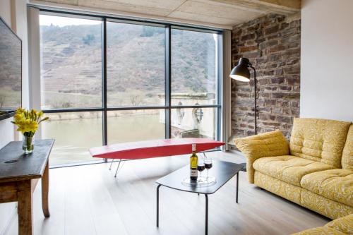 a living room with a couch and a table at Hotel Villa Vie Cochem in Cochem