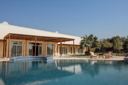 a swimming pool in front of a building at Jolie Ville Hotel & Spa Kings Island Luxor in Luxor