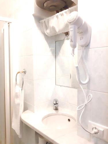 a bathroom with a blow dryer and a sink at The Terrace in Vernazza