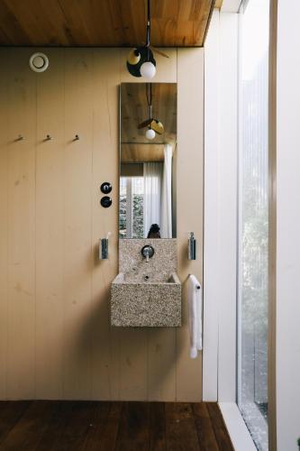 a bathroom with a sink and a mirror at Inferniño Apartments in Santiago de Compostela