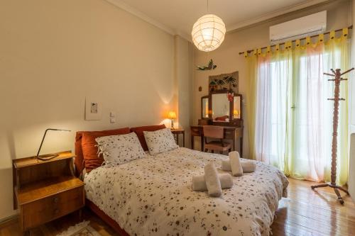 a bedroom with a bed with two towels on it at Art Deco Spacious Appartment close to centre in Athens