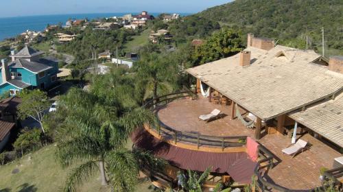 an aerial view of a large house with a roof at Luxury Suites Vila Indonésia in Garopaba