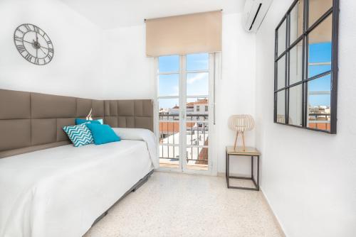 a bedroom with a bed and a clock on the wall at Myramar Premium Center in Málaga