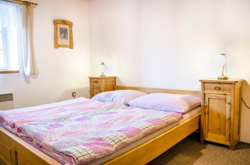 a bedroom with a bed and two night stands at Kovárna in Nová Paka