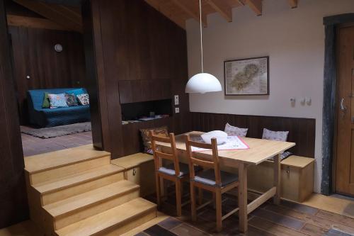 a dining room with a table and chairs and a couch at Quinta dos Baldo in Freixo de Espada à Cinta