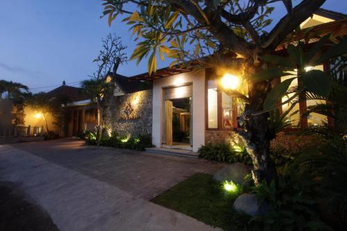 a house with lights on the side of it at Uma Karan in Seminyak