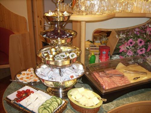 a display of cheese and other food on a table at Apart-Pension Oberreiter in Fusch an der Glocknerstraße