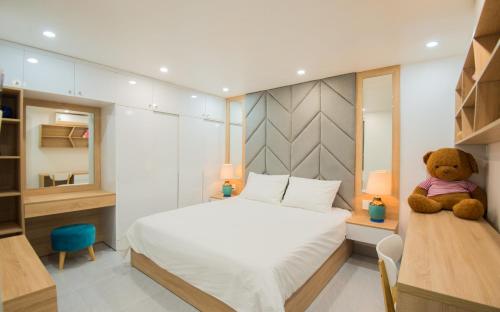 a bedroom with a teddy bear sitting on a bed at Kim Phu Villa Hoi An in Hoi An