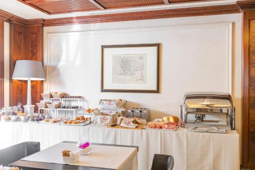 a room with a table with food on it at River Chateau Hotel in Rome