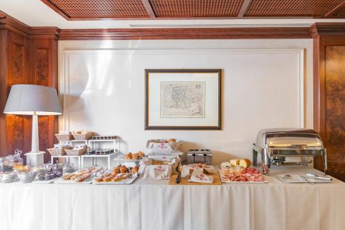 a table with a bunch of food on it at River Chateau Hotel in Rome