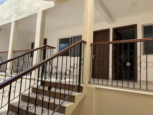 a set of stairs in a house with wrought iron railings at Hotel Catedral Valladolid Yucatan in Valladolid