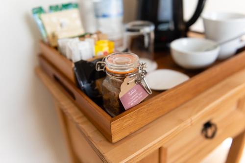 a jar of food sitting on a wooden counter at Blue Swallow in Penrith