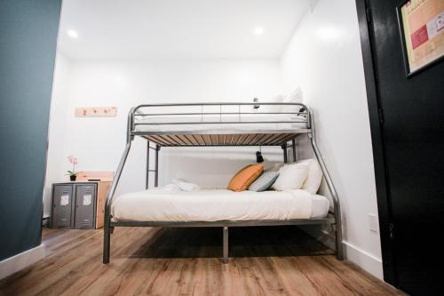 a metal bunk bed with pillows on it in a room at Auberge Saintlo Montréal Hostel in Montréal