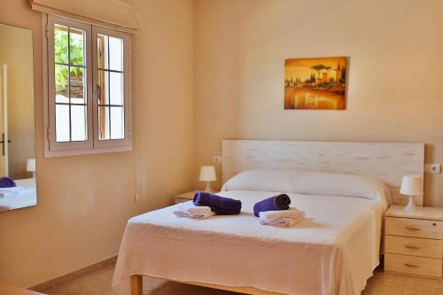 a bedroom with a bed with a doll on it at V Es Pujols Formentera rustick in Es Pujols
