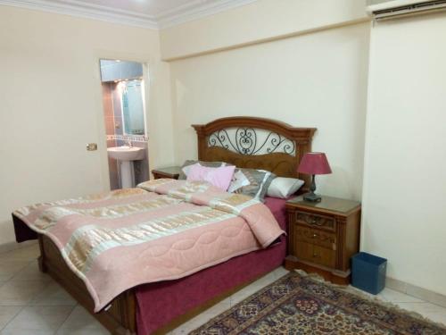 a bedroom with a bed and a dresser and a mirror at Your Dream Apartment in Agouza "FAMILY ONLY" in Cairo