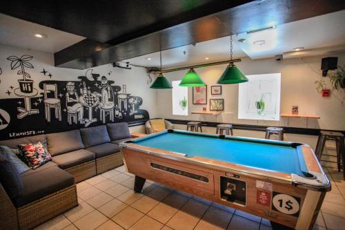 a living room with a pool table in it at Auberge Saintlo Montréal Hostel in Montreal