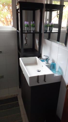 a bathroom with a white sink and a mirror at Stella Marina in Principina a Mare