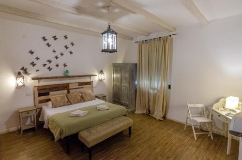a bedroom with a bed and a table and a dining room at Domatia in Barletta