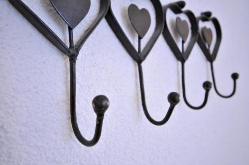 a group of hooks with hearts on a wall at Hotel-Pension Faneskla in Silbertal