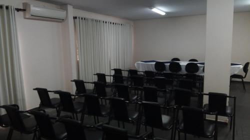 a room with chairs and a table in it at Hotel Riviera Lins in Lins