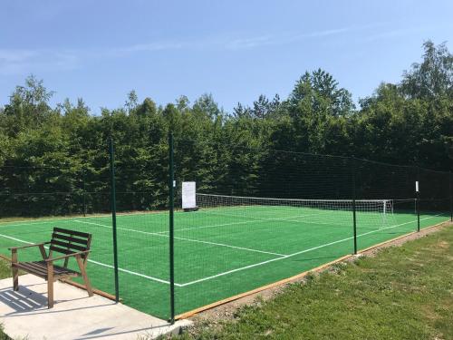 a tennis court with a bench on top of it at Pensjonat Zacisze in Czchów