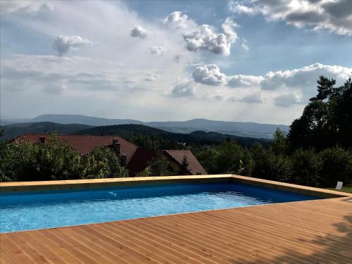 a swimming pool with a view of the mountains at Pensjonat Zacisze in Czchów