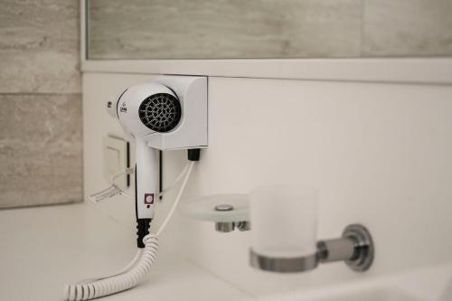 a bathroom with a blow dryer on a sink at Aizarker in La Plata