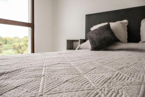 a bedroom with a white bed with a window at Aizarker in La Plata