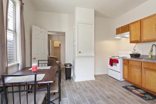 a kitchen with a table and a kitchen with a refrigerator at N Broad Studios in New Orleans
