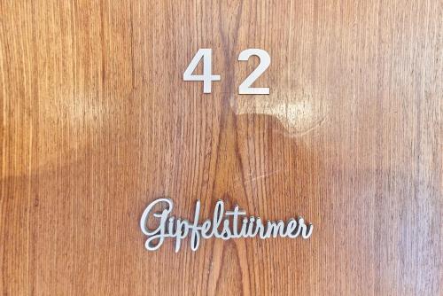 a wooden door with the number fourventhventhimeter on it at Hotel Marmotte in Saas-Fee