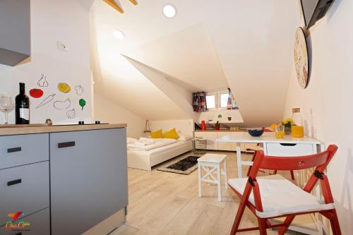 a kitchen and living room with a loft at Apartments Opa Opa in Rijeka