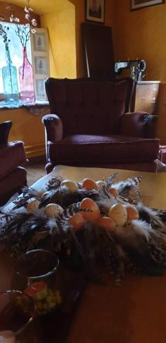 a pile of fruit on a table in a living room at Gorska Reka Guesthouse in Zreče